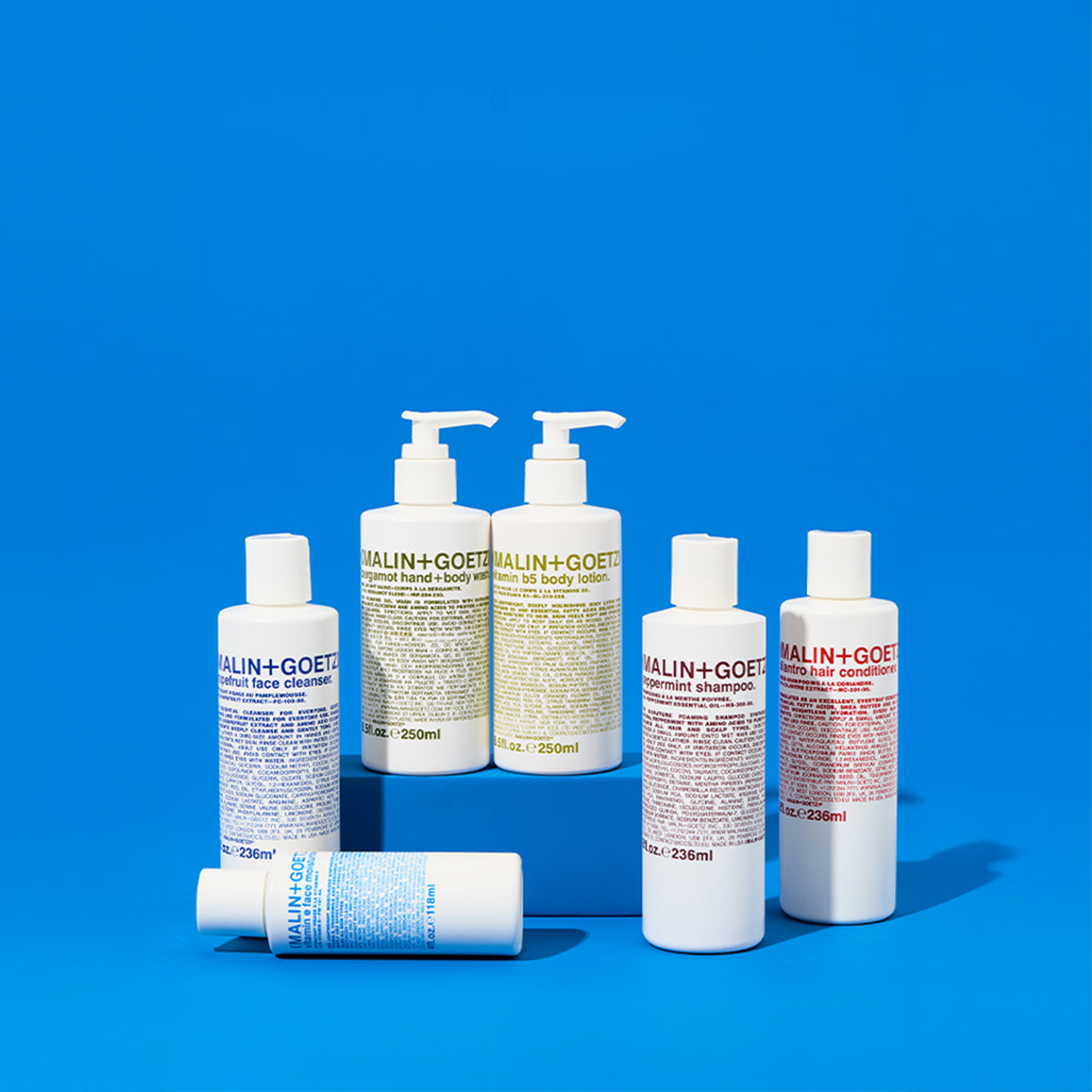 2-step essentials — face, body, and hair products on blue